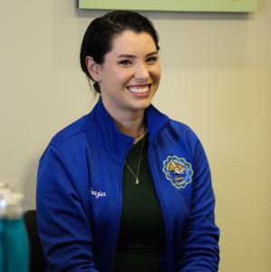 Photo of Allie Frazier, a woman with short brown hair pulled Photo of Allie Frazier, a woman with short brown hair pulled